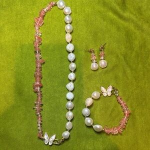 White baroque pearls, pink rose quartz chips, and butterfly pendants.